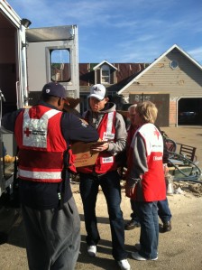 20and Robbie Gould and former player Rashied Davis unload supplies from the Red Cross emergency response vehicle.
